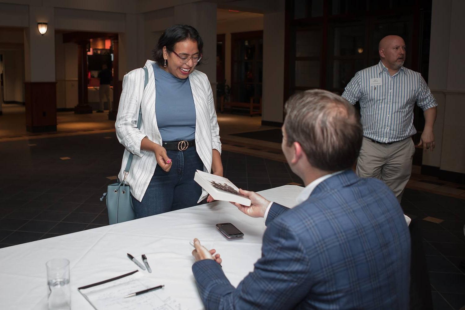 person signing a book